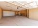 Large garage with ample storage space, a rolling garage door, and access door at 7101 E Cholla St, Scottsdale, AZ 85254