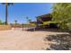Large outdoor space with horse corrals, a covered area for animals, and palm trees at 7101 E Cholla St, Scottsdale, AZ 85254