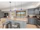 Bright kitchen with granite countertops, blue pendant lights, and stainless steel barstools at 7101 E Cholla St, Scottsdale, AZ 85254