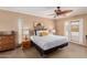 Comfortable bedroom with brick wall, ceiling fan, and access to the outdoors at 7101 E Cholla St, Scottsdale, AZ 85254
