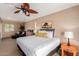 Inviting bedroom with white bedding, brick wall, and a ceiling fan at 7101 E Cholla St, Scottsdale, AZ 85254