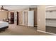 Bedroom with open closet, a view of the bathroom, and neutral wall colors at 7101 E Cholla St, Scottsdale, AZ 85254