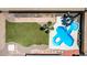 An aerial view of a backyard pool with grass area, stone walkway, and an outdoor furniture cover at 7101 E Cholla St, Scottsdale, AZ 85254