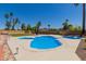 A freeform pool surrounded by lush landscaping and a spacious patio area at 7101 E Cholla St, Scottsdale, AZ 85254