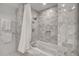 Bright bathroom with modern bathtub, white shower curtain, and tiled walls at 7117 E Rancho Vista Dr # 6007, Scottsdale, AZ 85251