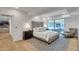 Modern bedroom featuring a sitting area, hardwood floors, and serene natural light from large windows at 7117 E Rancho Vista Dr # 6007, Scottsdale, AZ 85251