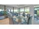 Bright dining room features a glass table, modern chairs, and stunning views of the outdoor landscape at 7117 E Rancho Vista Dr # 6007, Scottsdale, AZ 85251