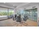 Comfortable dining room with glass table and bar next to sliding glass doors and outdoor seating at 7117 E Rancho Vista Dr # 6007, Scottsdale, AZ 85251