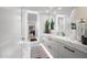 Bright bathroom featuring a modern vanity with marble countertops, sleek hardware, and stylish, illuminated mirrors at 7167 E Rancho Vista Dr # 3002, Scottsdale, AZ 85251