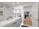 Bright, stylish bathroom featuring marble countertops, double mirrors, and an open doorway to the home's interior at 7167 E Rancho Vista Dr # 3002, Scottsdale, AZ 85251