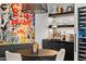 Stylish dining area showcases colorful artwork, a modern bar with wine storage and elegant decor at 7167 E Rancho Vista Dr # 3002, Scottsdale, AZ 85251