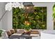 Well-lit dining room featuring a large green living wall, elegant light fixture, and seating for eight at 7167 E Rancho Vista Dr # 3002, Scottsdale, AZ 85251