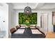 Bright dining room features a large green living wall and modern light fixture over the dining table at 7167 E Rancho Vista Dr # 3002, Scottsdale, AZ 85251