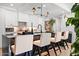 Close up of the black kitchen island with a marble countertop, breakfast bar, and modern lighting at 7167 E Rancho Vista Dr # 3002, Scottsdale, AZ 85251