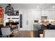 Bright kitchen featuring white cabinets, a wine fridge, and a black island with a marble countertop at 7167 E Rancho Vista Dr # 3002, Scottsdale, AZ 85251