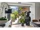Modern living area with large windows overlooking a lush outdoor space and a unique bear sculpture at 7167 E Rancho Vista Dr # 3002, Scottsdale, AZ 85251