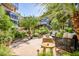 Spacious patio with fire pit, hammock, and comfortable seating amid lush landscaping at 7167 E Rancho Vista Dr # 3002, Scottsdale, AZ 85251