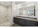 Bathroom with double sinks, marble counters, a soaking tub, and a glass-enclosed shower at 7180 E Kierland Blvd # 916, Scottsdale, AZ 85254