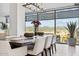 Bright dining room features a modern chandelier, large windows, and panoramic city and mountain views at 7180 E Kierland Blvd # 916, Scottsdale, AZ 85254