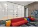 Bright squash court with glass walls, colorful seating, and modern design elements at 7180 E Kierland Blvd # 916, Scottsdale, AZ 85254