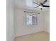 Bedroom with natural light provided by a large window and ceiling fan at 7551 W Pasadena Ave, Glendale, AZ 85303