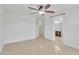 Spacious bedroom with ceiling fan and adjacent bathroom featuring a walk-in shower at 7551 W Pasadena Ave, Glendale, AZ 85303