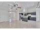 Bright kitchen features dark cabinetry, stainless steel appliances, and an island with stone countertops at 7551 W Pasadena Ave, Glendale, AZ 85303