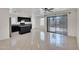 Bright kitchen with dark cabinetry and island with stone countertops, adjacent to a dining area and sliding door at 7551 W Pasadena Ave, Glendale, AZ 85303