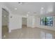 Spacious living room with tile floors, crown molding, recessed lighting, and lots of natural light from the window at 7551 W Pasadena Ave, Glendale, AZ 85303