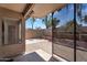 View of the outdoor patio that's covered with brick flooring, with a partial view of the backyard at 7551 W Pasadena Ave, Glendale, AZ 85303