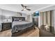 Comfortable bedroom with a large bed, TV, ceiling fan, dresser, and bedside tables at 7625 E Camelback Rd # B138, Scottsdale, AZ 85251