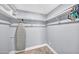 Walk-in closet featuring shelves and an ironing board at 7625 E Camelback Rd # B138, Scottsdale, AZ 85251
