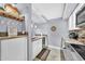 Bright kitchen featuring white cabinets, granite countertops, stainless steel appliances, and a wine rack at 7625 E Camelback Rd # B138, Scottsdale, AZ 85251