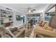 Open-concept living room with tile flooring, ceiling fan, built-in shelves, and sliding glass doors to the patio at 7625 E Camelback Rd # B138, Scottsdale, AZ 85251