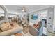 Spacious living room with comfortable seating, a TV, a ceiling fan, and an adjacent dining area at 7625 E Camelback Rd # B138, Scottsdale, AZ 85251
