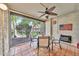 Relaxing screened-in patio with outdoor dining, a fan, and views of the community at 7625 E Camelback Rd # B138, Scottsdale, AZ 85251