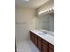 Bathroom featuring vanity with solid surface countertop, and a large mirror at 8947 N 84Th Way, Scottsdale, AZ 85258