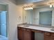 Bathroom featuring dual sinks, vanity lighting, and a large mirror at 8947 N 84Th Way, Scottsdale, AZ 85258
