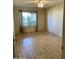 Bedroom with wood floors, a ceiling fan, and a large window providing natural light at 8947 N 84Th Way, Scottsdale, AZ 85258