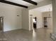 Bright living room with wood floors, beamed ceiling, and view into kitchen at 8947 N 84Th Way, Scottsdale, AZ 85258