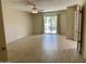 Bright living room with light-colored wood floors, ceiling fan, and sliding doors to the outdoors at 8947 N 84Th Way, Scottsdale, AZ 85258
