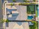 Aerial view of a backyard with a putting green, pool, and patio area at 10322 E Topaz Ave, Mesa, AZ 85212