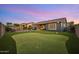 Spacious backyard with putting green, mature trees, and well manicured lawn at 10322 E Topaz Ave, Mesa, AZ 85212