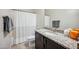 Bathroom featuring granite counters, a white shower curtain and dark cabinets at 10322 E Topaz Ave, Mesa, AZ 85212