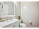 Charming powder room featuring a decorative mirror and a sleek, modern vanity at 10322 E Topaz Ave, Mesa, AZ 85212