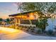 A modern clubhouse exterior with desert landscaping and inviting entrance at dusk at 10322 E Topaz Ave, Mesa, AZ 85212