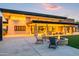 Clubhouse exterior with stone accents, ample seating, and cozy fire pit at 10322 E Topaz Ave, Mesa, AZ 85212