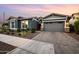 Beautiful single-story home boasts a paved driveway, lush landscaping, and a two-car garage at 10322 E Topaz Ave, Mesa, AZ 85212