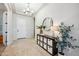 Bright foyer with neutral tones, decorative mirror, and ample storage at 10322 E Topaz Ave, Mesa, AZ 85212