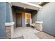 Inviting front porch with stone pillars, decorative door, and welcoming decor at 10322 E Topaz Ave, Mesa, AZ 85212